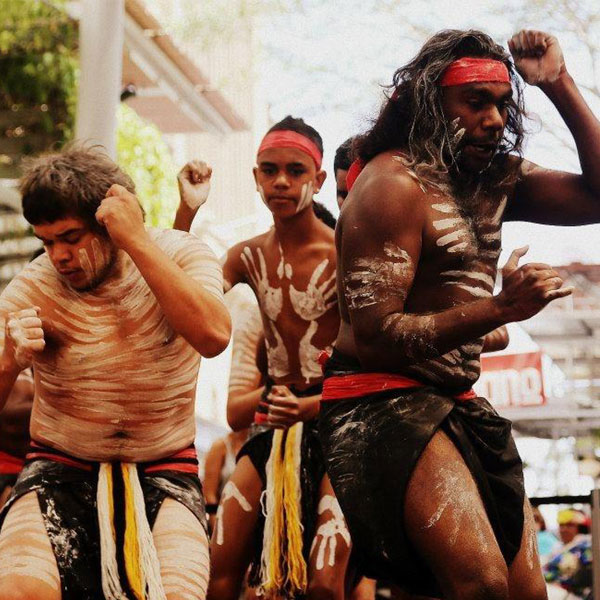 3 aboriginal dancers dressed traditionally with paint